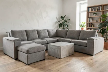 Canapé modulable en tissu gris disposé en L dans un salon scandinave moderne avec plancher en chêne clair